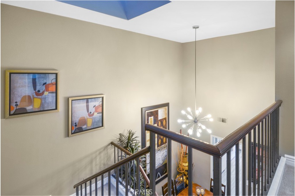 33766 Captains Lane, Unit 200 Dana Point, CA 92629 - Photo 21 of 38 a view of staircase with furniture and a chandelier