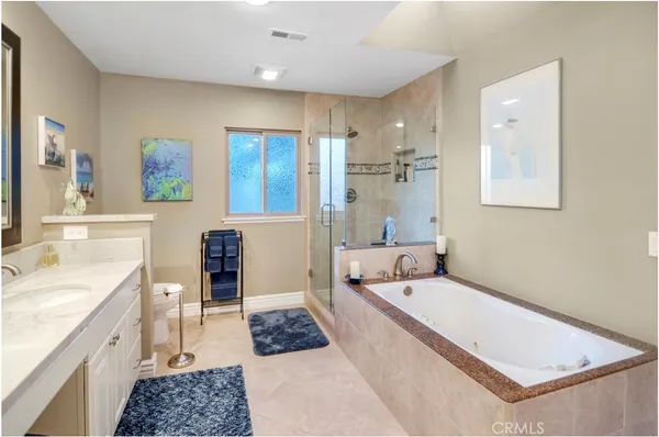 a bathroom with a tub a sink and mirror