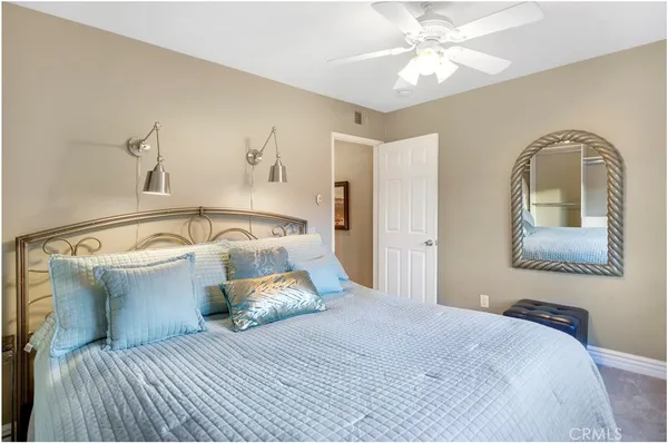 a bedroom with a bed and a mirror