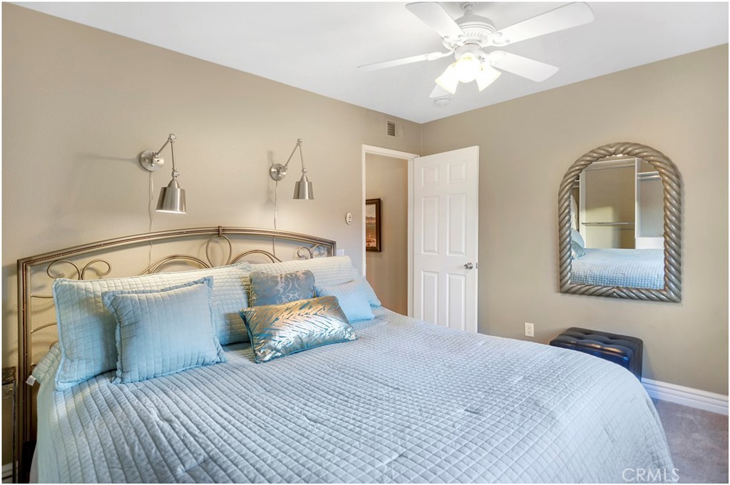 33766 Captains Lane, Unit 200 Dana Point, CA 92629 - Photo 26 of 38 a bedroom with a bed and a chandelier