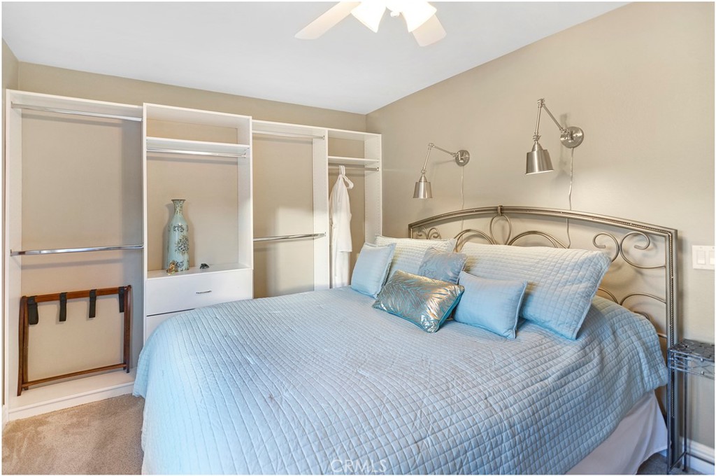 33766 Captains Lane, Unit 200 Dana Point, CA 92629 - Photo 27 of 38 a bedroom with a bed and a mirror