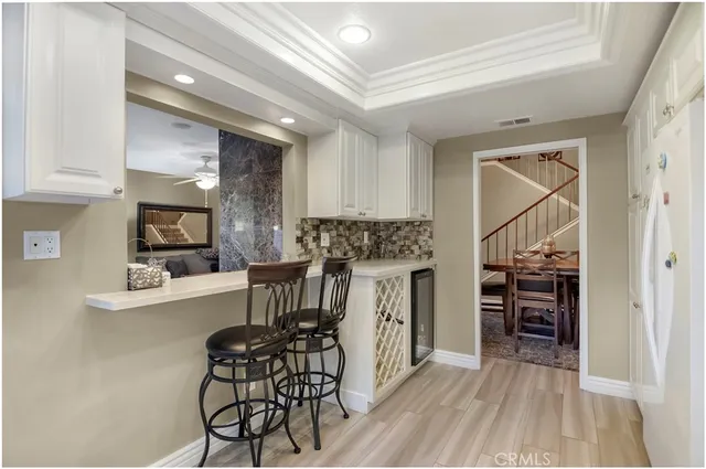 a kitchen with stainless steel appliances a refrigerator and a stove top oven
