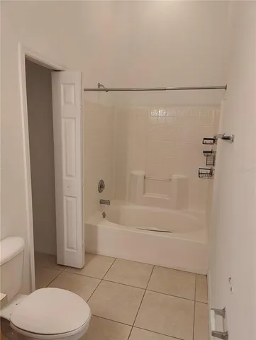 a bathroom with a toilet and shower