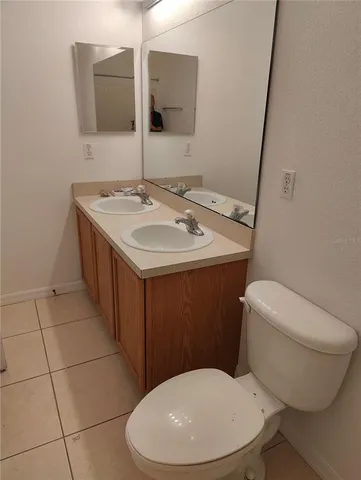 a bathroom with a toilet a sink and mirror