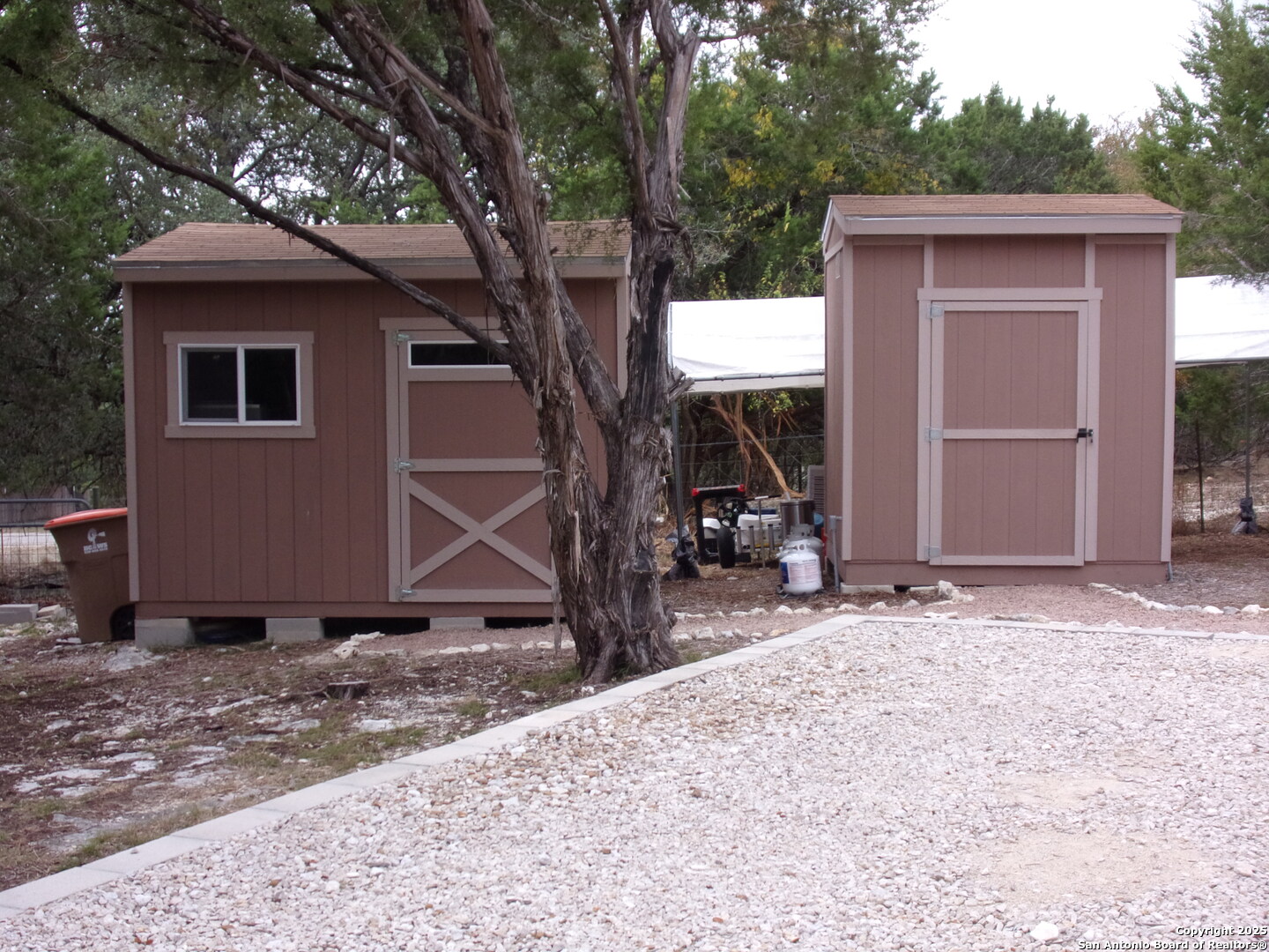2471 Rolling River Spring Branch, TX 78070 - Photo 3 of 24 a backyard of a house with table and chairs