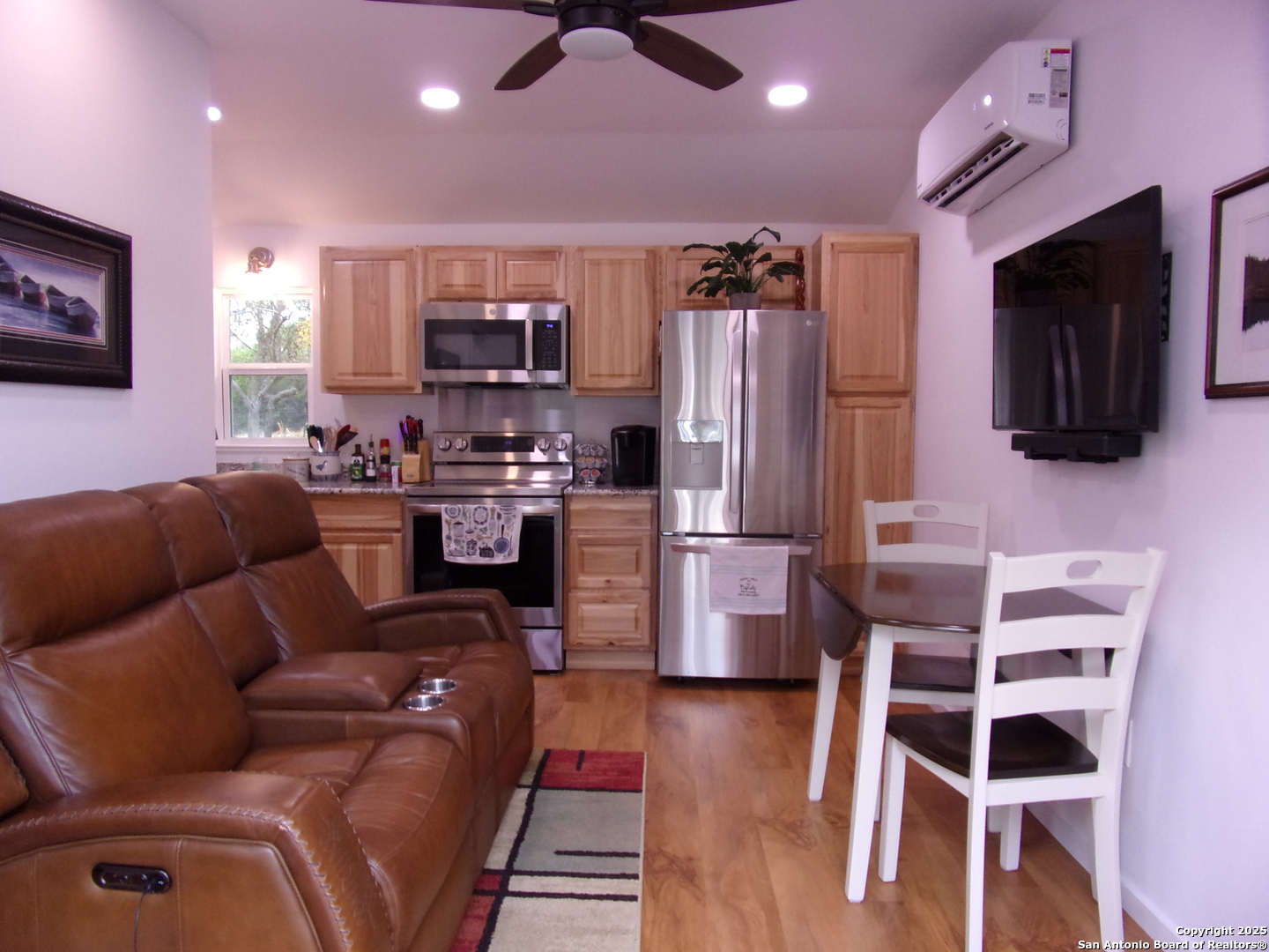 2471 Rolling River Spring Branch, TX 78070 - Photo 4 of 24 a living room with stainless steel appliances furniture and a flat screen tv