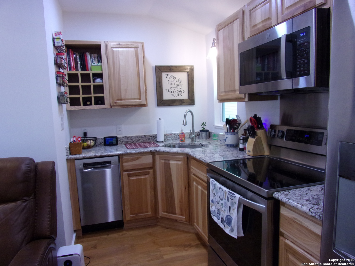 2471 Rolling River Spring Branch, TX 78070 - Photo 7 of 24 a kitchen with stainless steel appliances granite countertop a sink stove and microwave