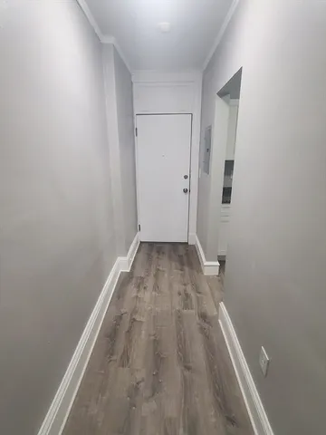 a view of a room with wooden floor and white walls