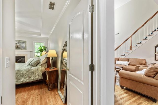 a view of a livingroom with a chandelier fan and windows