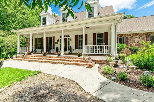a view of a pathway with a house and garden