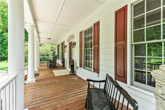 a view of a dining room with furniture a chandelier and wooden floor