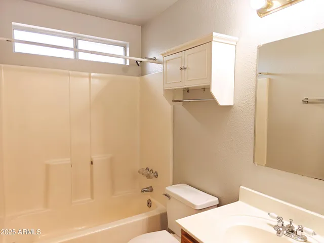 a bathroom with a shower and a toilet