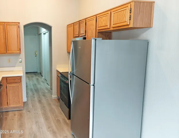 a metallic refrigerator freezer sitting in a kitchen