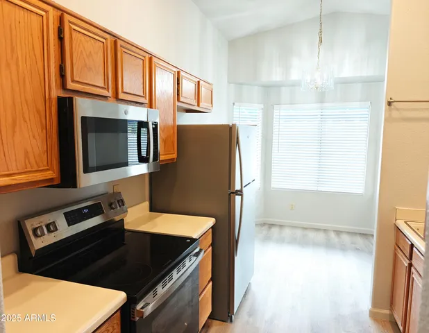 a kitchen with a refrigerator stove and microwave