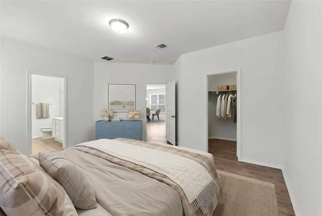 a bedroom with a large bed and a chandelier