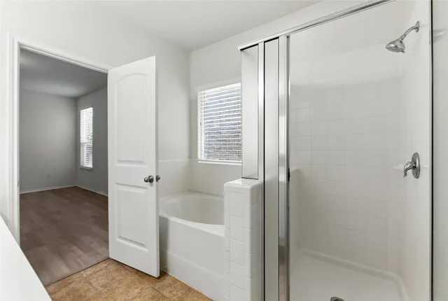 a bathroom with a bathtub and a shower