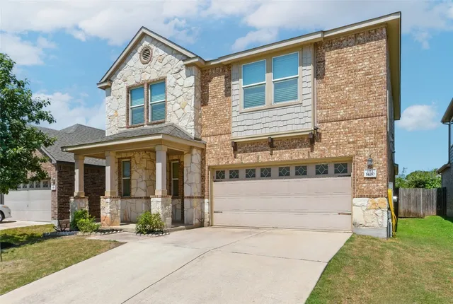 a front view of a house with a garden and plants
