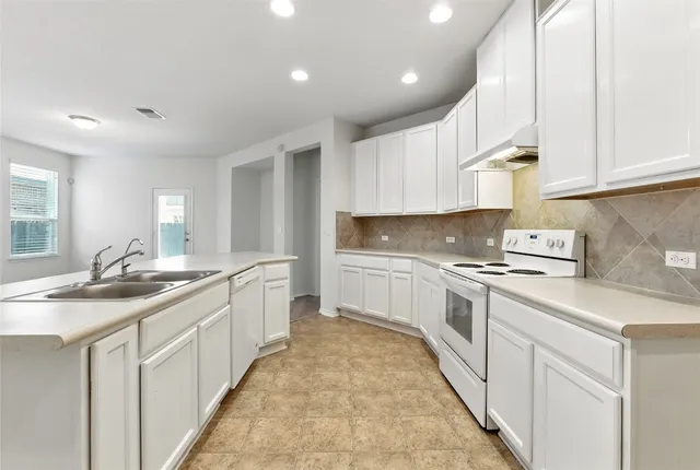 a kitchen with stainless steel appliances granite countertop a sink and cabinets