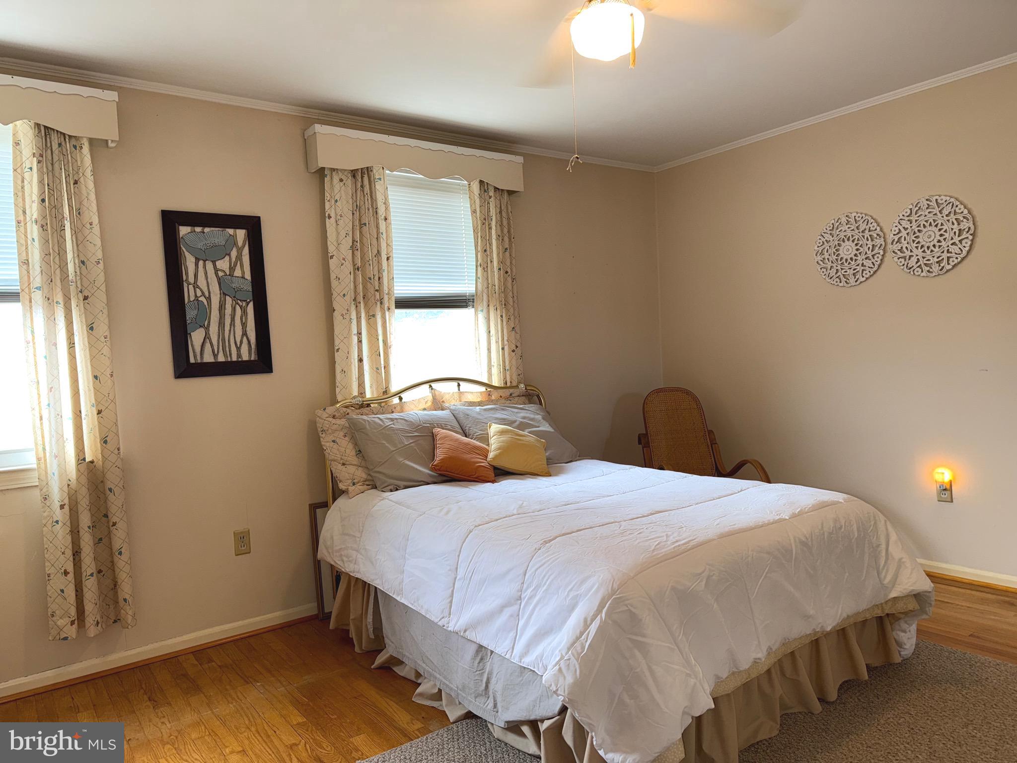 8144 Gray Haven Road Baltimore, MD 21222 - Photo 11 of 37 a bedroom with a bed and a window