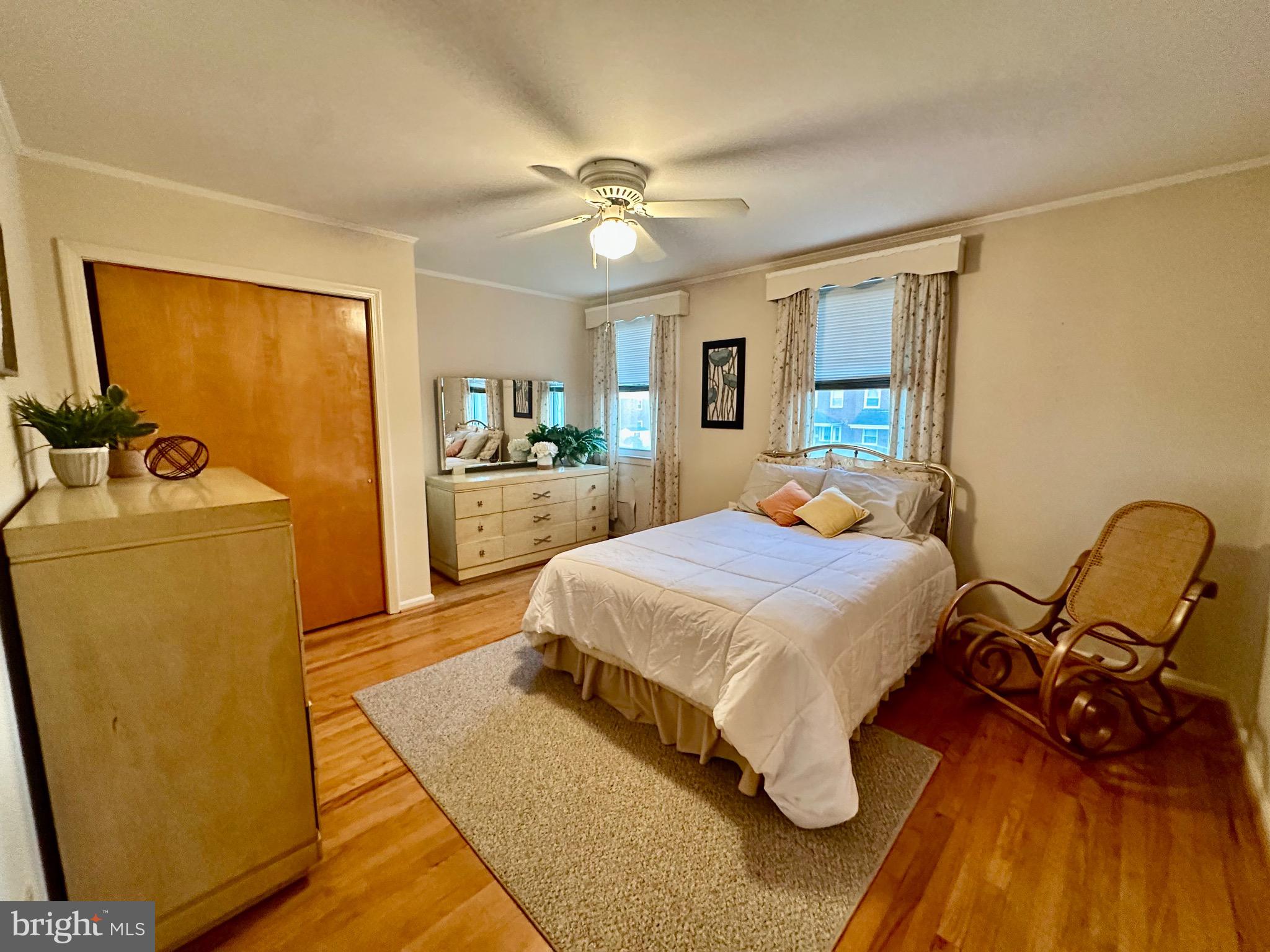 8144 Gray Haven Road Baltimore, MD 21222 - Photo 13 of 37 a bedroom with a bed and wooden floor