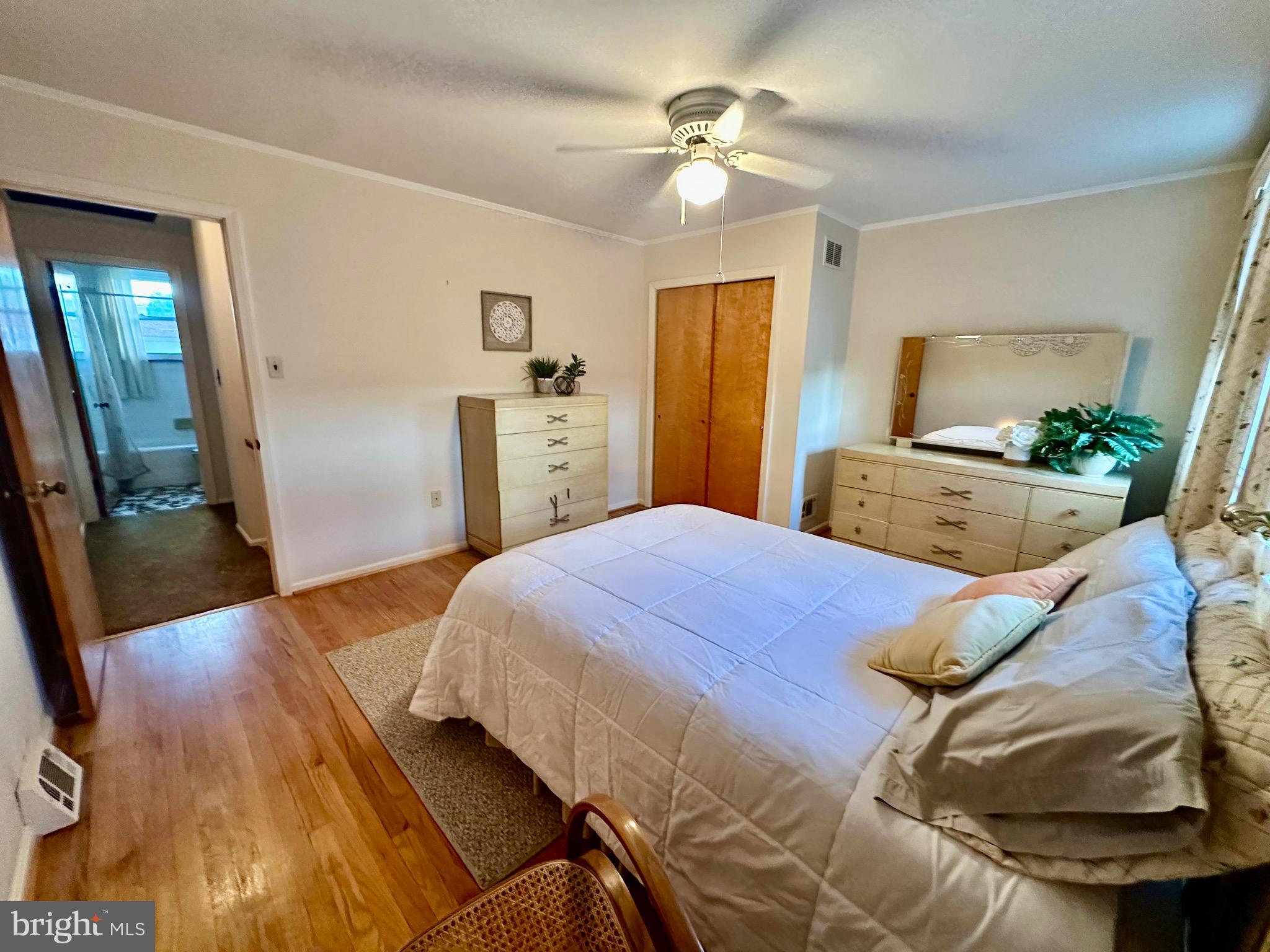 8144 Gray Haven Road Baltimore, MD 21222 - Photo 14 of 37 a bedroom with a bed and a chandelier