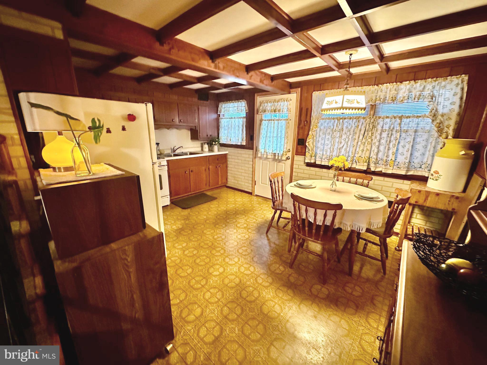 8144 Gray Haven Road Baltimore, MD 21222 - Photo 21 of 37 a dining room with furniture and a floor to ceiling window