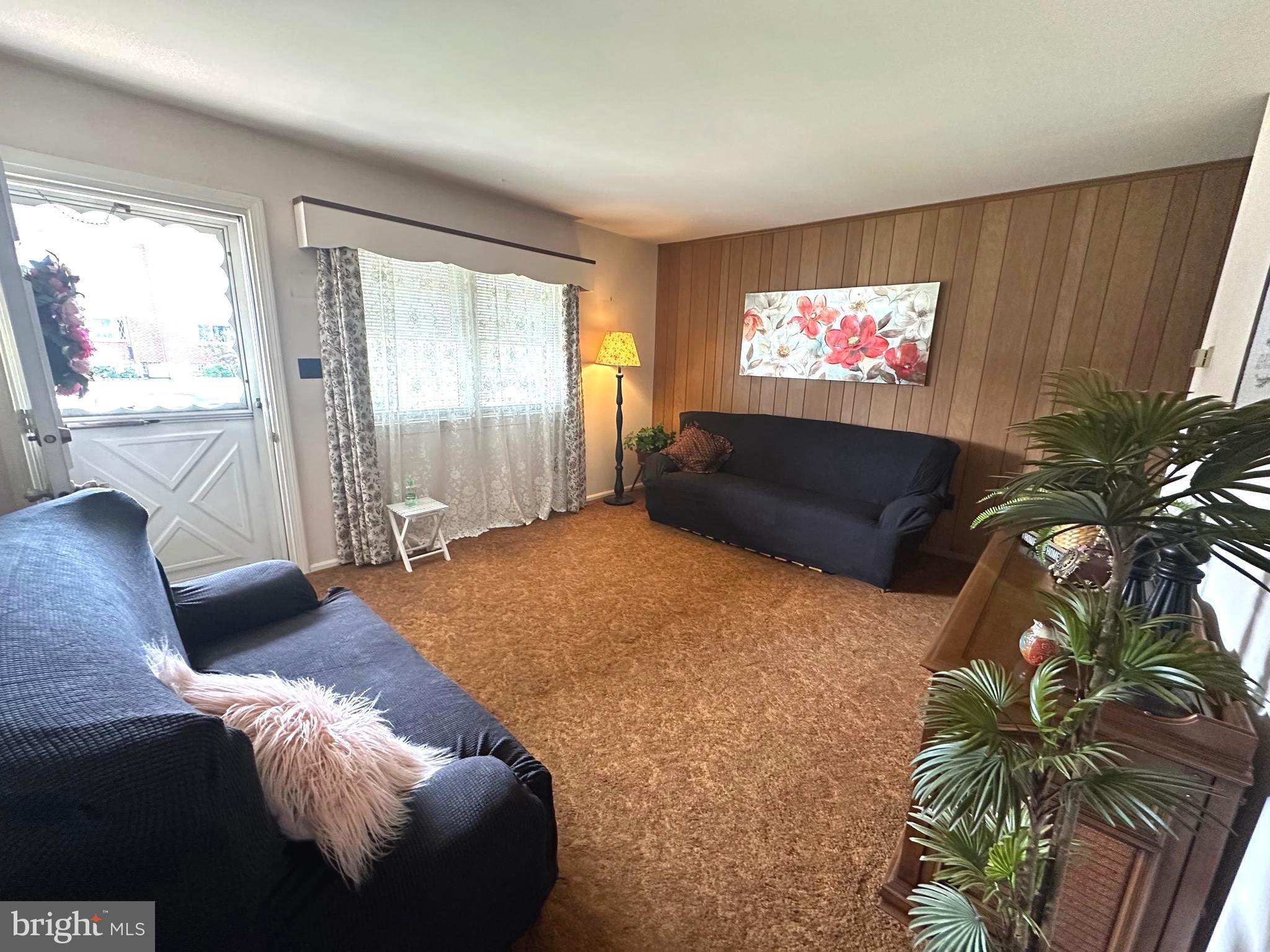 8144 Gray Haven Road Baltimore, MD 21222 - Photo 3 of 37 a living room with furniture and a flat screen tv