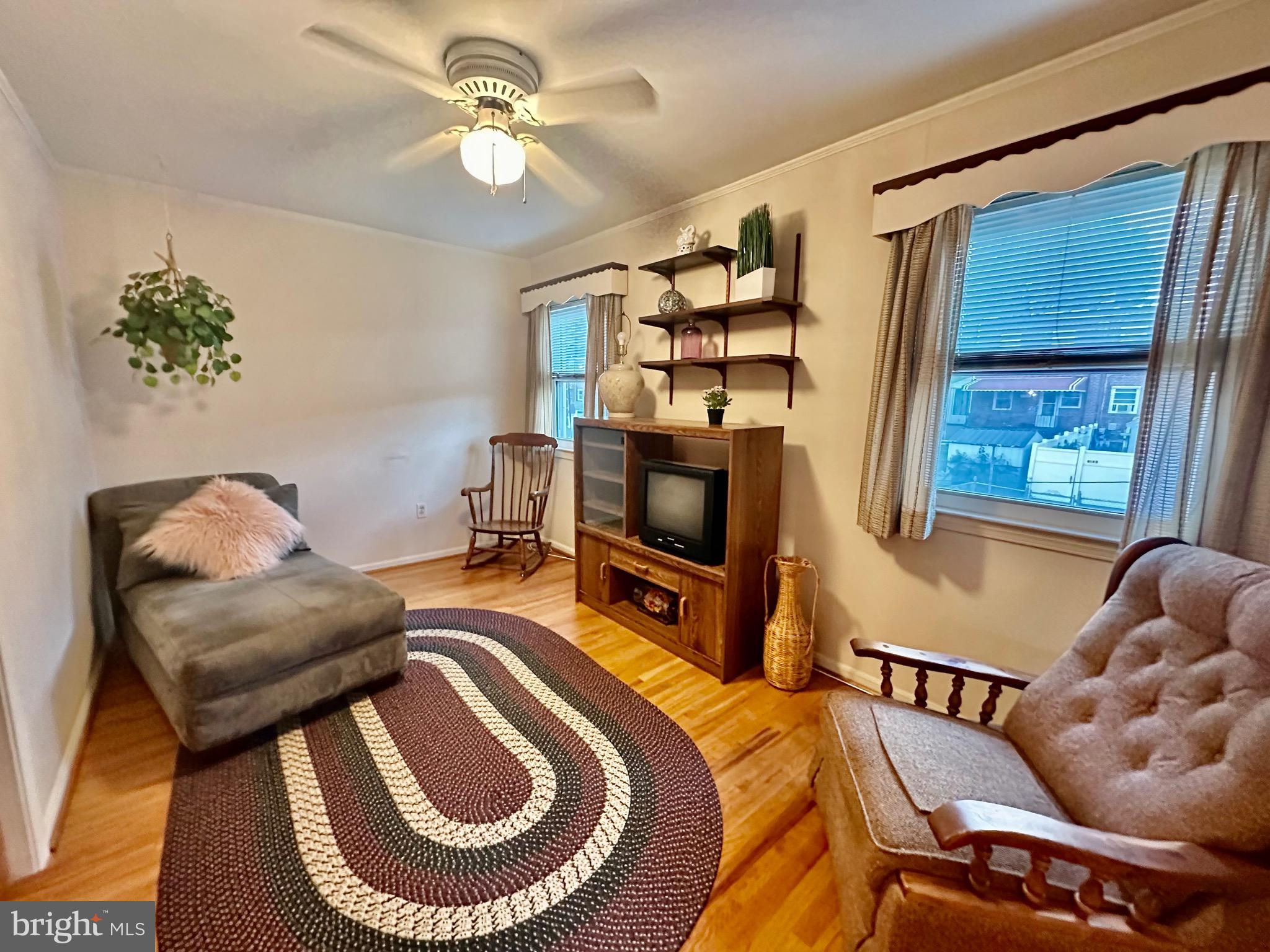 8144 Gray Haven Road Baltimore, MD 21222 - Photo 6 of 37 a bedroom with furniture and a chair