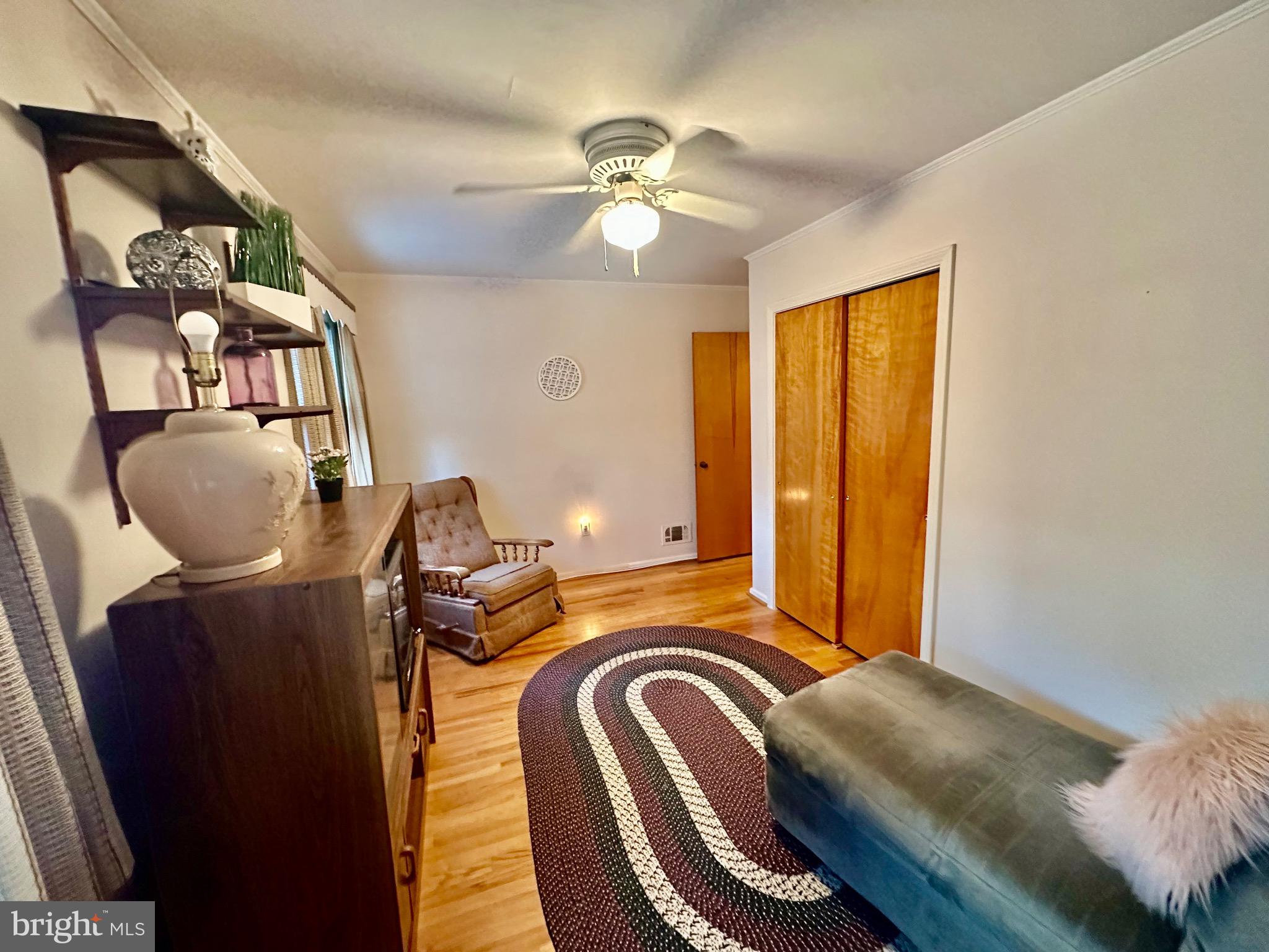 8144 Gray Haven Road Baltimore, MD 21222 - Photo 7 of 37 a bedroom with bed and a chandelier