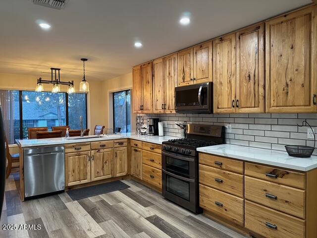 304 North Mogollon Trail Payson, AZ 85541 - Photo 5 of 22 a kitchen with stainless steel appliances granite countertop a stove a sink and a microwave