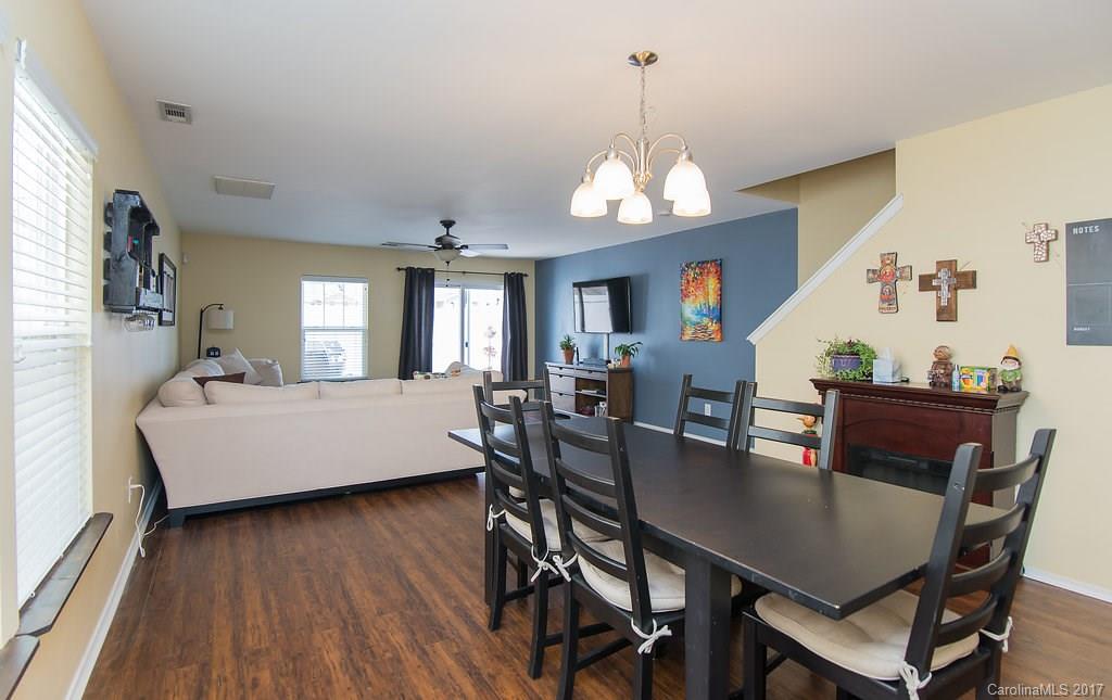 309 River Clay Road, Unit 309 Fort Mill, SC 29708 - Photo 8 of 23 a view of a dining room with furniture a chandelier and wooden floor