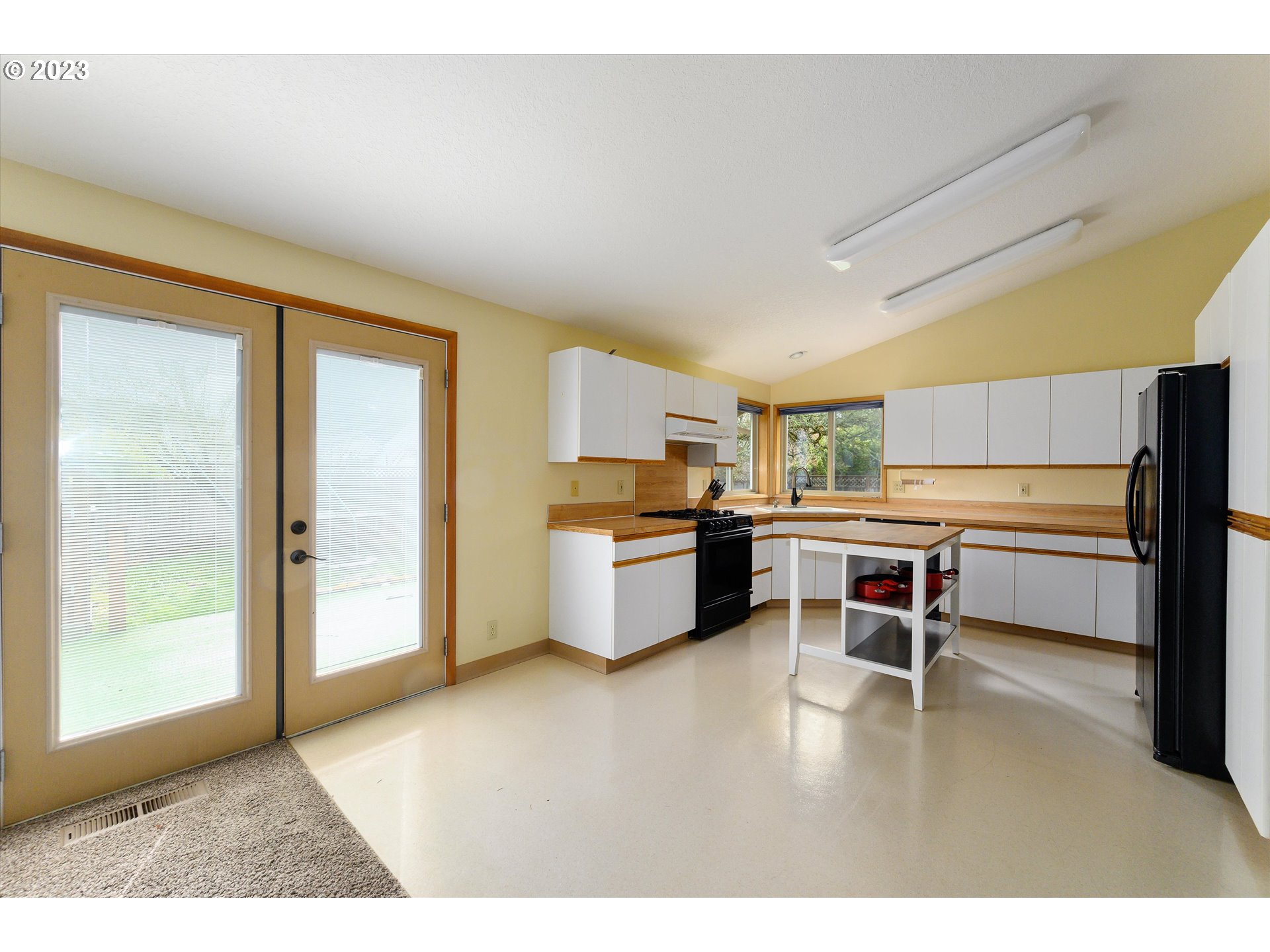 1811 D Street Forest Grove, OR 97116 - Photo 15 of 34 a kitchen with a refrigerator and white cabinets