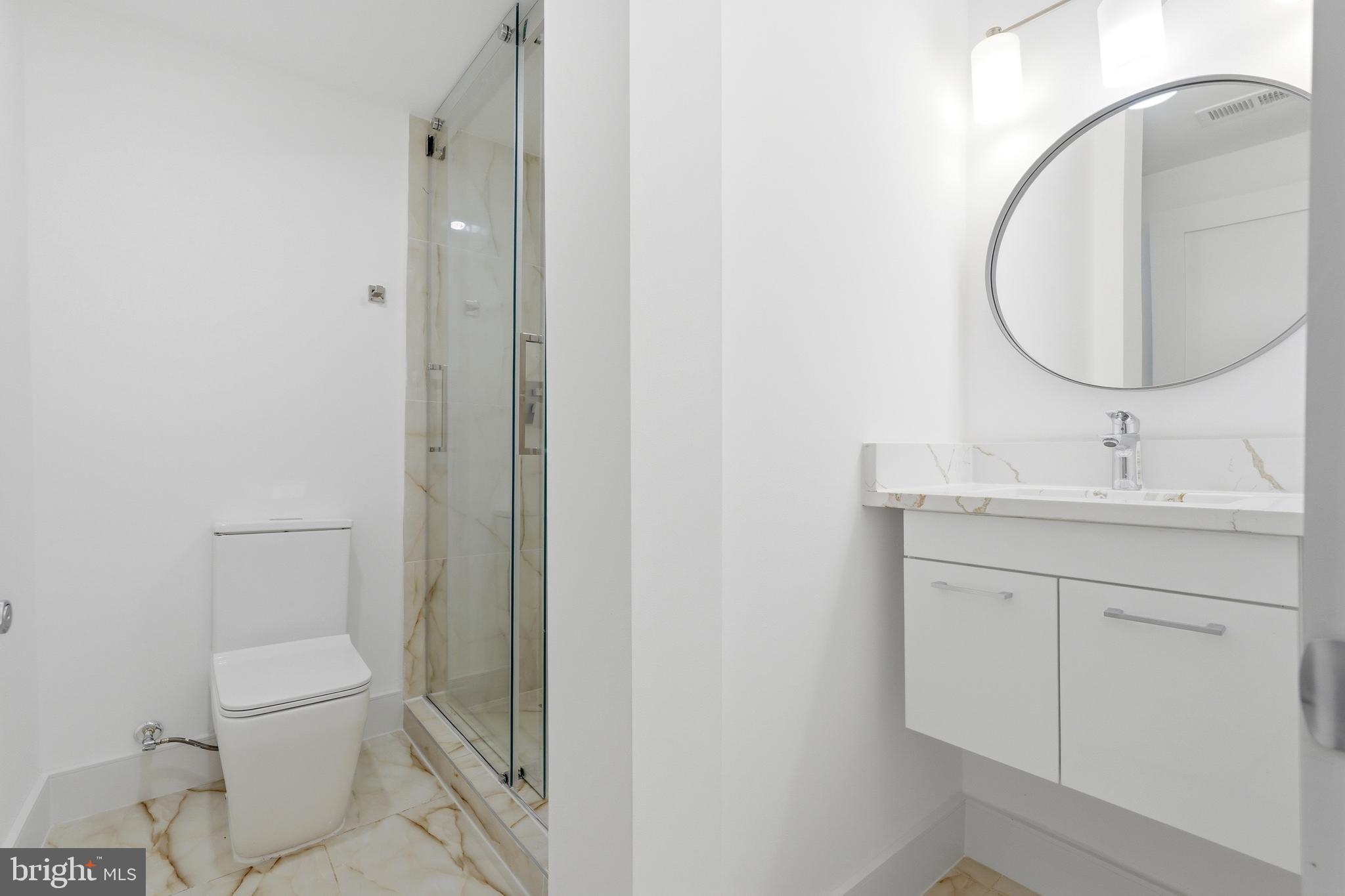 1810 Central Place Northeast, Unit 1 Washington, DC 20002 - Photo 25 of 36 a bathroom with a sink a toilet and a mirror