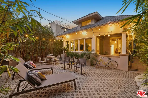 a view of a patio with dining table and chairs