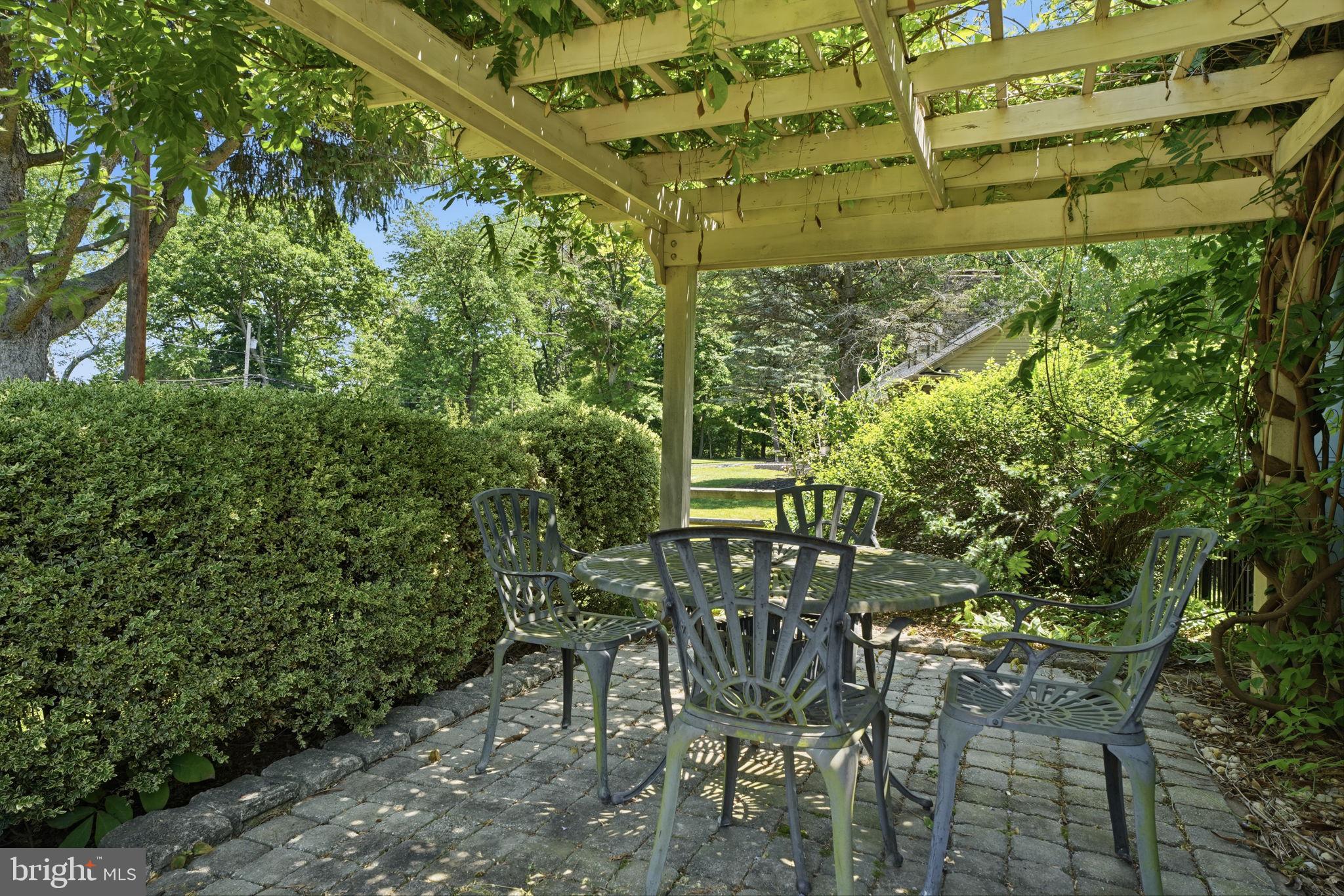 621 River Road Yardley, PA 19067 - Photo 66 of 75 a view of a yard with table and chairs and potted plants