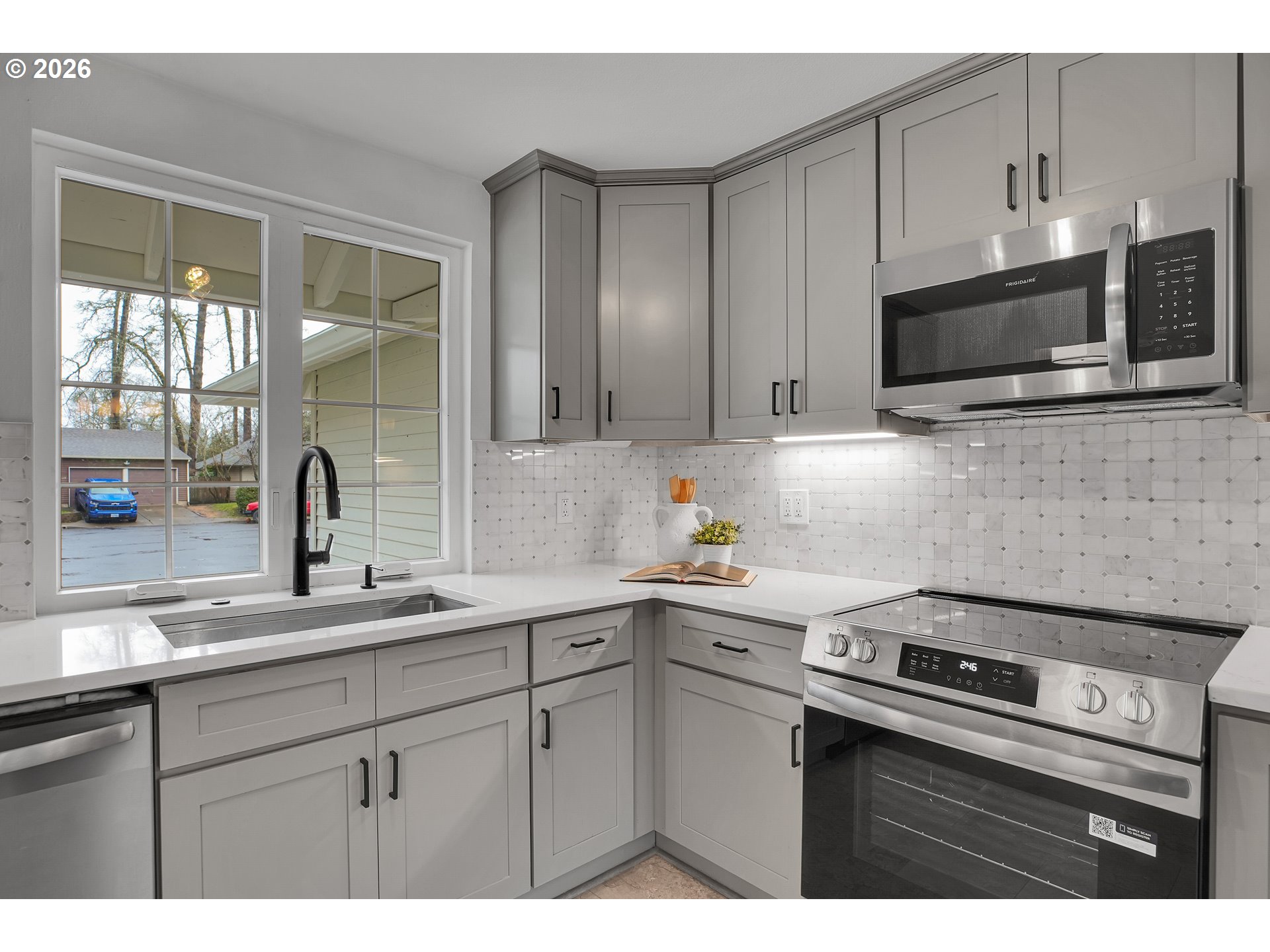 20332 Southwest Rock Court Beaverton, OR 97003 - Photo 19 of 47 a kitchen with stainless steel appliances white cabinets and a sink