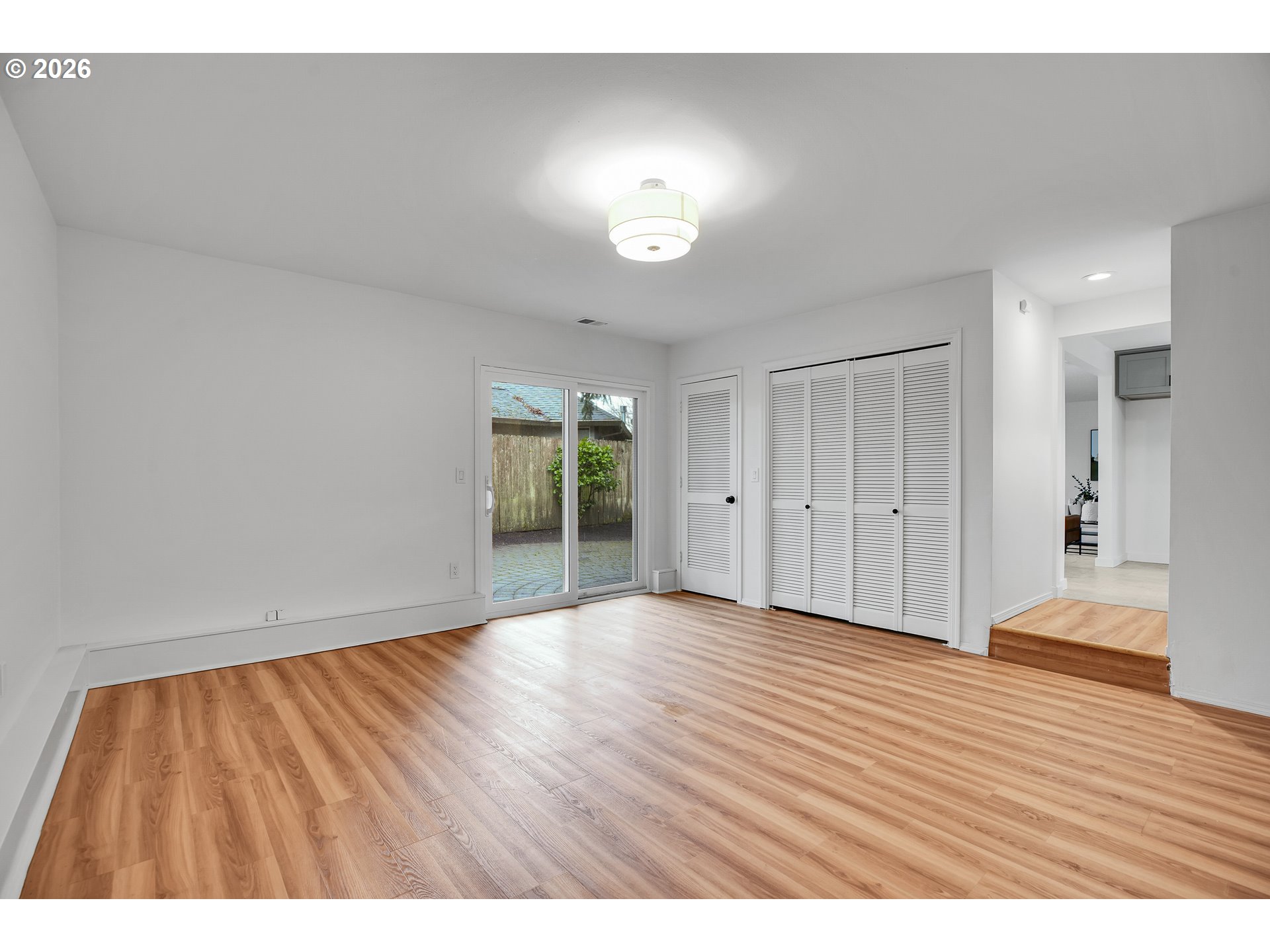 20332 Southwest Rock Court Beaverton, OR 97003 - Photo 24 of 47 a view of an empty room with wooden floor and a window