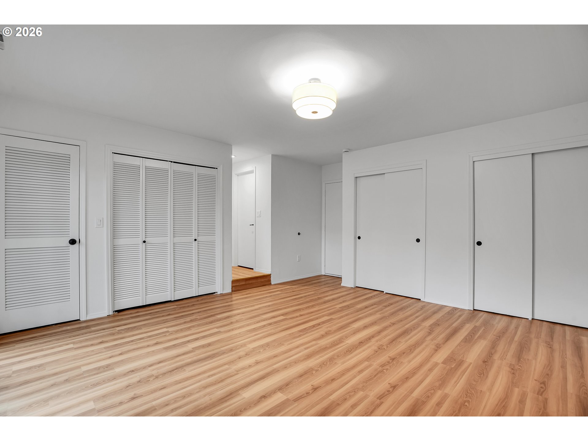20332 Southwest Rock Court Beaverton, OR 97003 - Photo 25 of 47 a view of an empty room with wooden floor