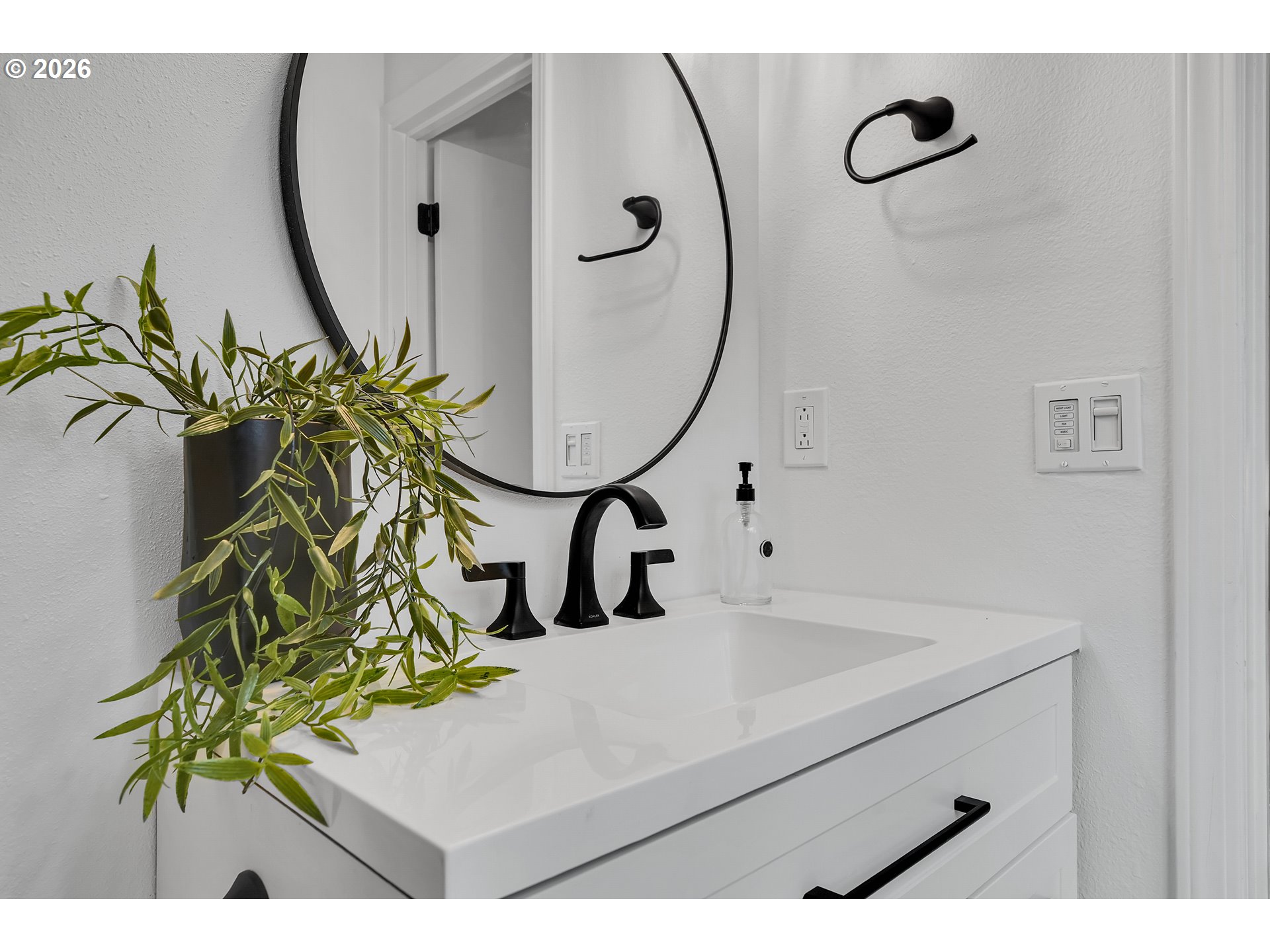 20332 Southwest Rock Court Beaverton, OR 97003 - Photo 33 of 47 a bathroom with a granite countertop sink a mirror and a vase of flowers