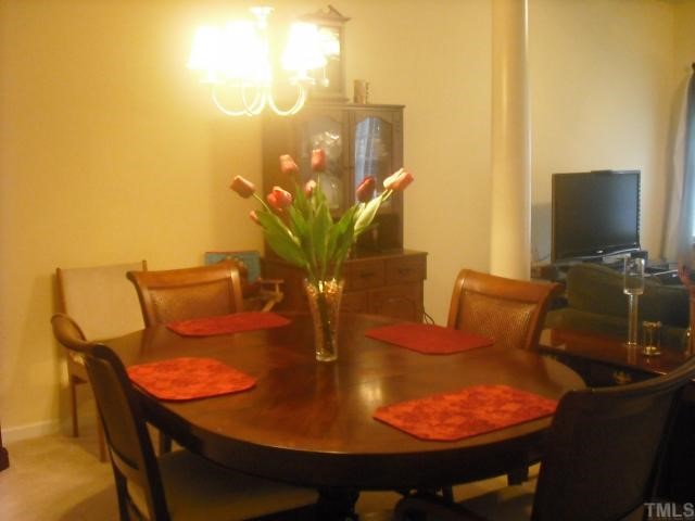504 Erie Road Raleigh, NC 27610 - Photo 2 of 4 a outdoor dining space with furniture and a potted plant