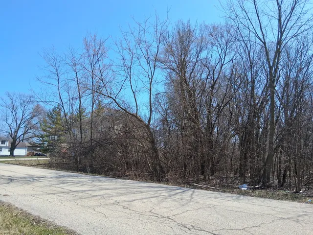 a view of house with a snow on the road