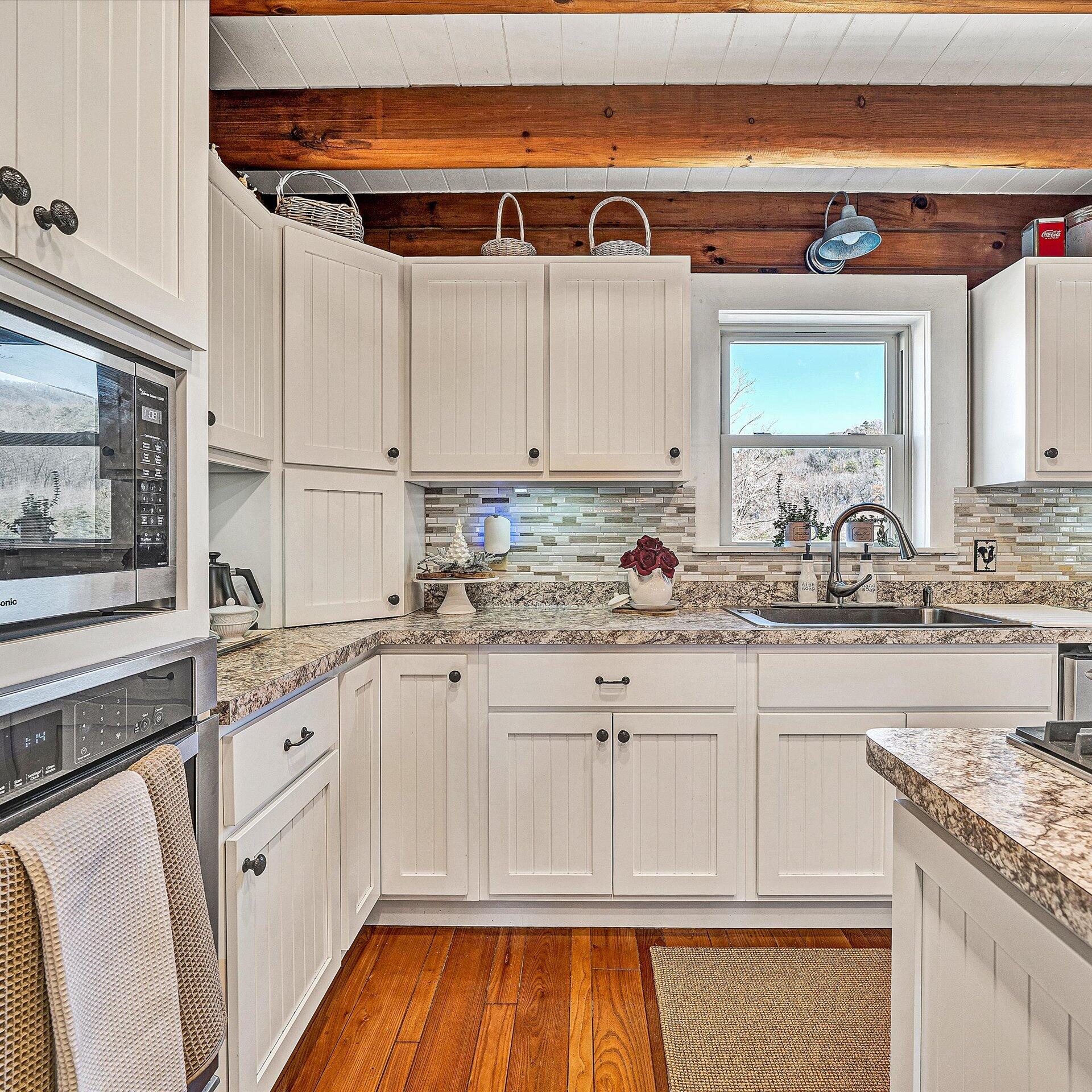 1504 Hutchison Road Newport, VA 24128 - Photo 23 of 99 a kitchen with granite countertop white cabinets and white appliances