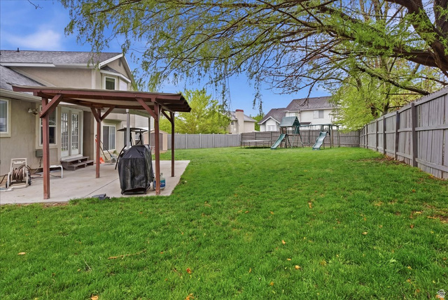 7975 Showcase Lane Sandy, UT 84094 - Photo 25 of 29 Backyard offers easily accessible patio, play area, and large playset