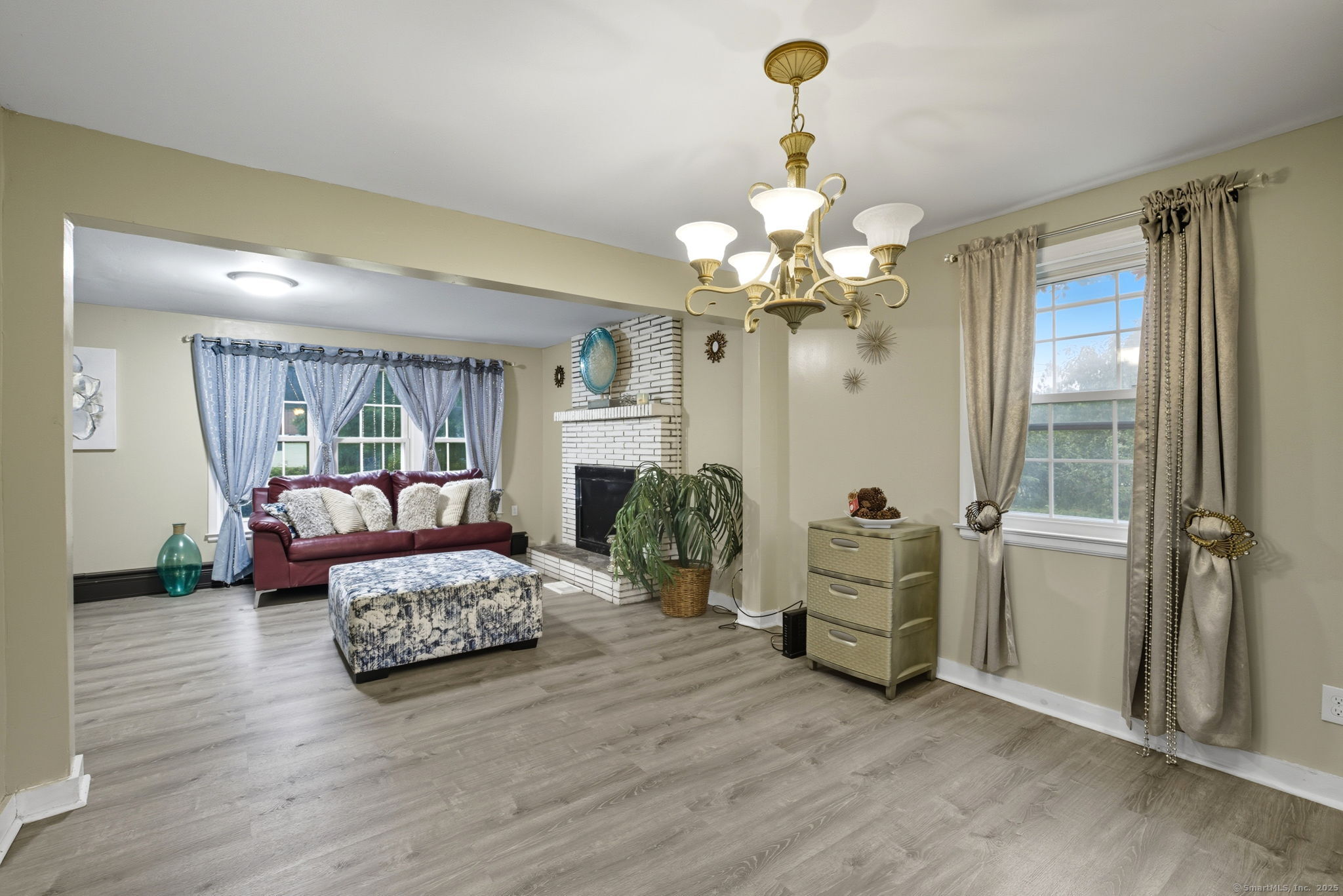 41 Chestnut Drive Windsor, CT 06095 - Photo 7 of 27 a living room with furniture and a chandelier