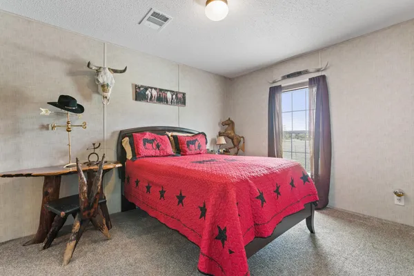 a bedroom with a bed and a table in it