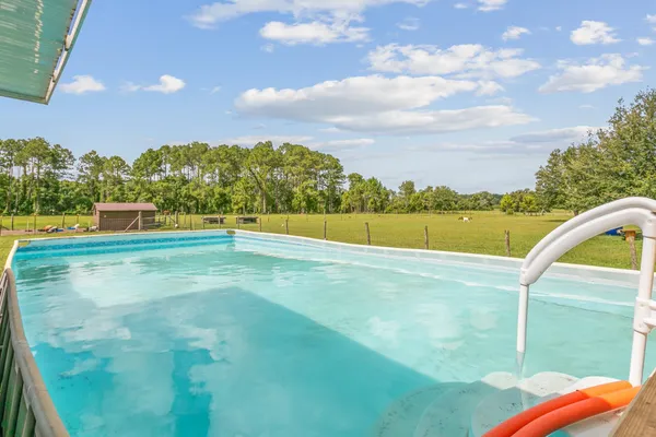 a view of a house with backyard porch and sitting area