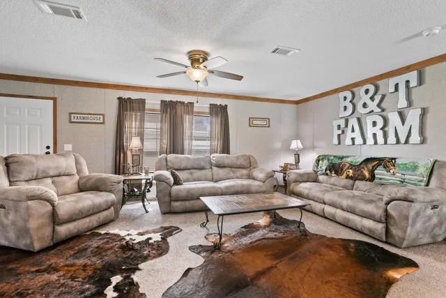 a kitchen with stainless steel appliances granite countertop a stove top oven a sink dishwasher a dining table and chairs with wooden floor