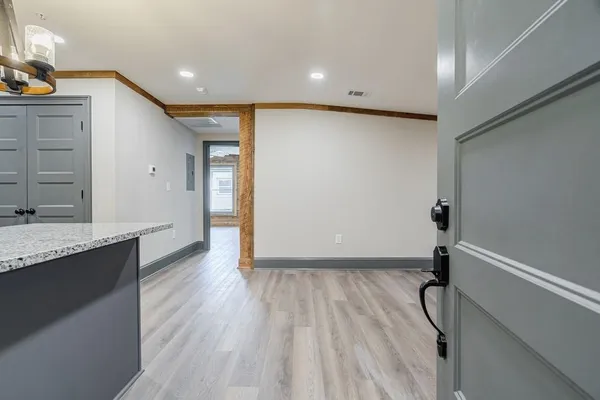 a view of a kitchen with a sink and wooden floor