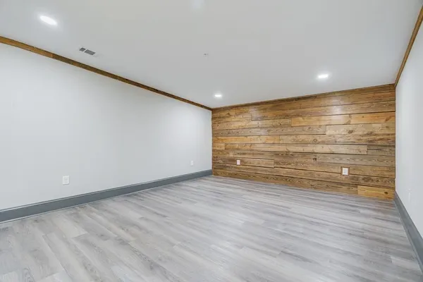 a view of room with wooden floor