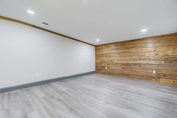 a view of room with wooden floor